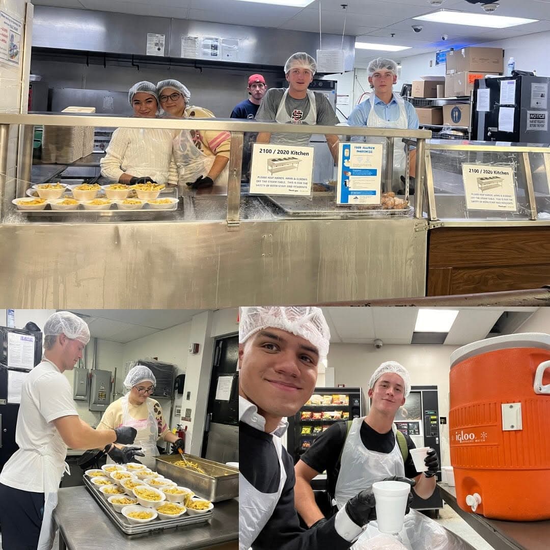 YouthServeCLE volunteers in hairnets and aprons plating pasta and serving drinks in the Lutheran Metropolitan Ministries kitchen
